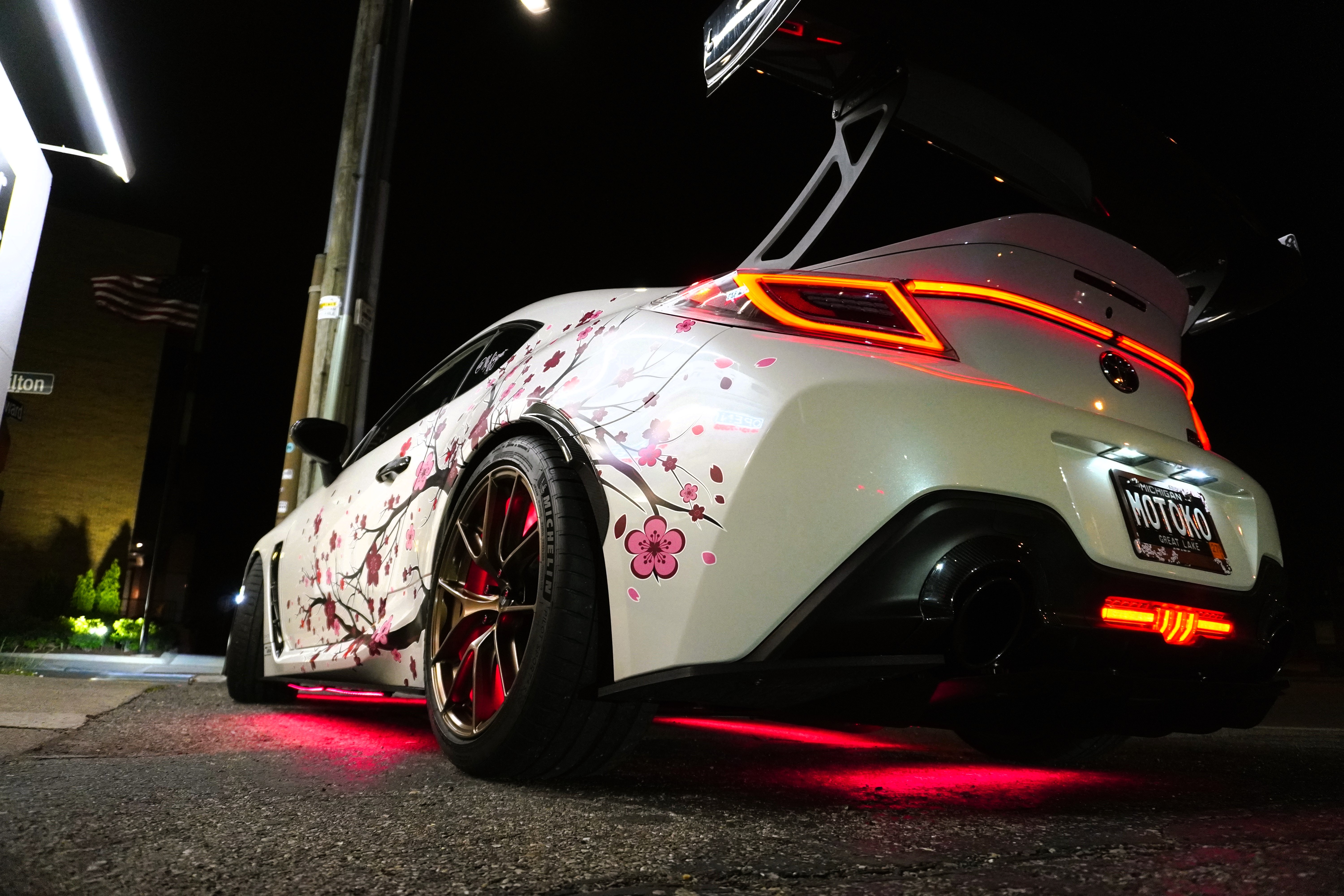 Custom vehicle parked showcasing detailing and underglow